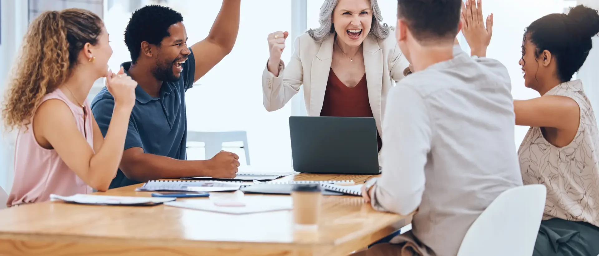 Business people celebration meeting goal, target and success while cheering during a meeting in a office. Advertising and marketing team happy about company profit and bonus salary from project